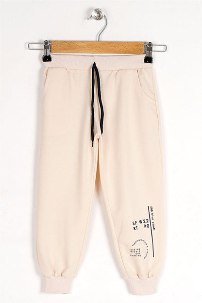 Boy's Stone Colored Looking Forward And Creating Printed Sweatpants